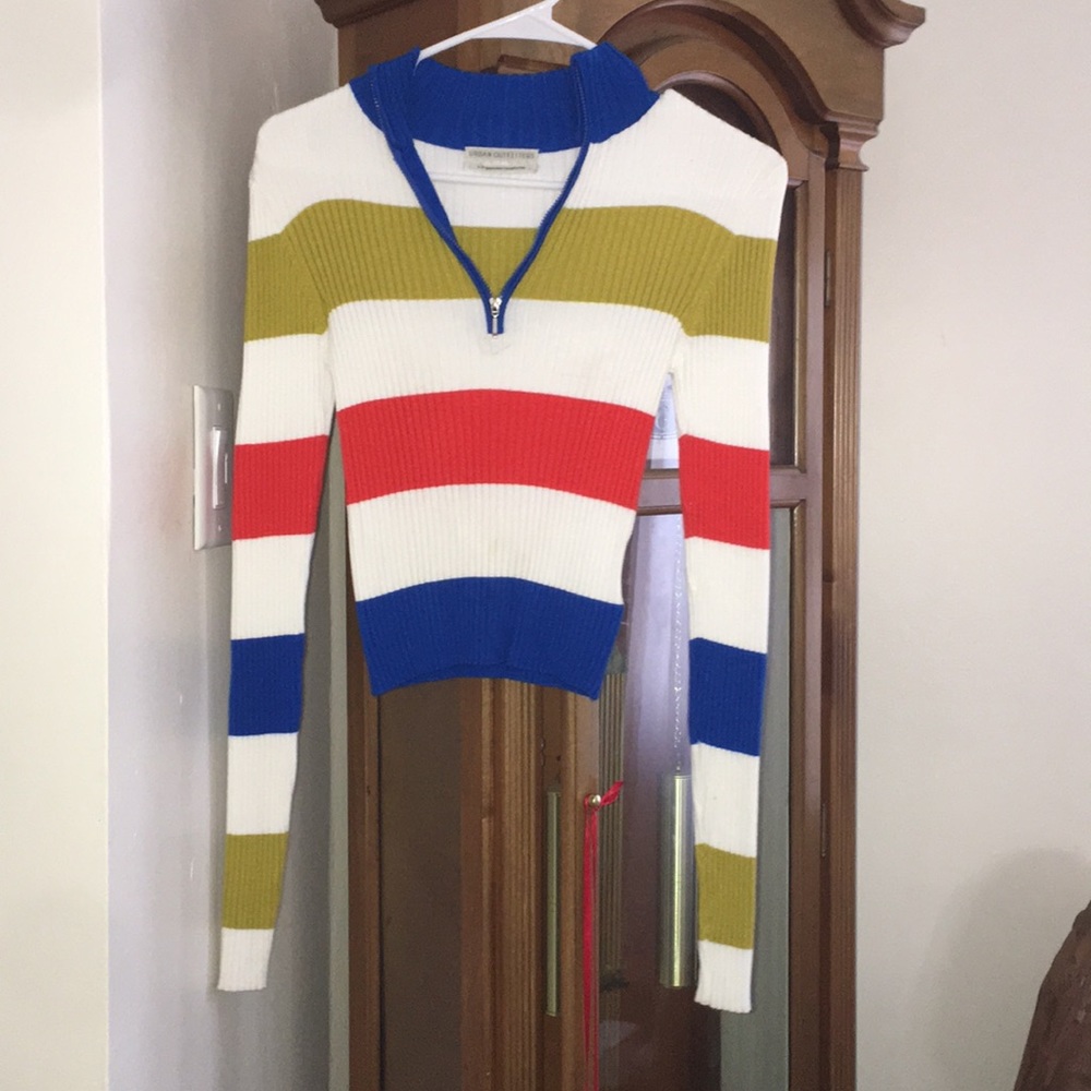 A thin long sleeve multi colored sweater.